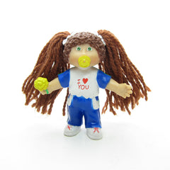 Cabbage Patch Kids miniature figurine with brown yarn hair and I Love You t-shirt