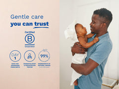 Man holding a baby with product features on a beige background