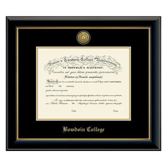 Diploma frame with glossy black moulding with gold fillet and black and gold matting. Gold sun seal medallion set into the mat on top of the diploma, BOWDOIN COLLEGE embossed in gold below.