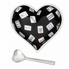 The Happy Heart Bowl With Spoon - Mah Jong by Inspired Generations is a heart-shaped bowl with a black interior and mahjong tile pattern, paired with a small silver heart-shaped spoon.