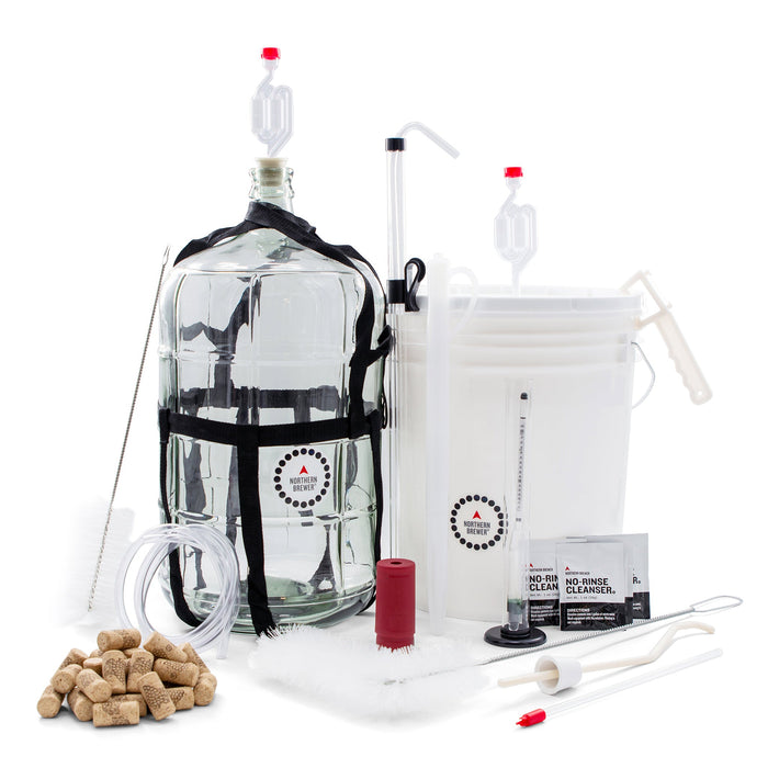 Master Vintner wine making starter kit with a glass carboy, fermentation buckets, airlocks, siphon, tubing, hydrometer, brushes, corks, and cleanser — everything needed to start making wine at home.
