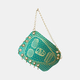 The artwork 'Mr. Rain Face' by Sunny Chapman features a whimsical turquoise acrylic illustration on paper, depicting a stylized face with geometric patterns and linear details. The piece is adorned with decorative gold chain and studs along its border, creating a unique mixed-media effect. The design combines folk art elements with contemporary styling, measuring 12x9 inches.