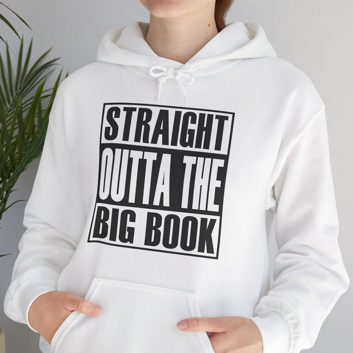 Person wearing a white hoodie with text 'STRAIGHT OUTTA THE BIG BOOK' in a casual setting.