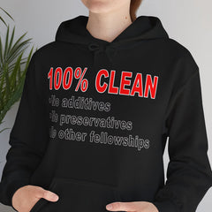 Person wearing a black hoodie with red and white text in a room with a plant.