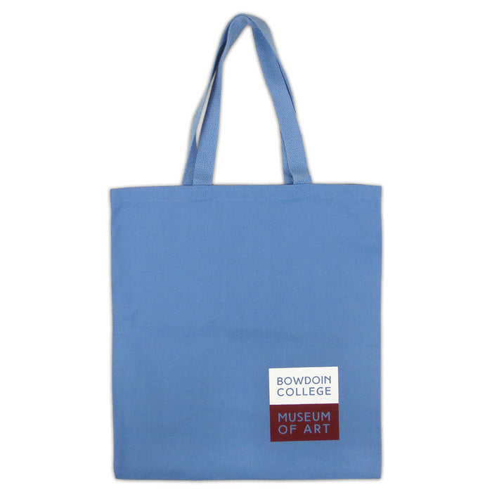 Back of sky blue canvas tote bag with square imprint in lower right corner--the top half of the square is white, with the words BOWDOIN COLLEGE inside, the bottom is red with the words MUSEUM OF ART inside.
