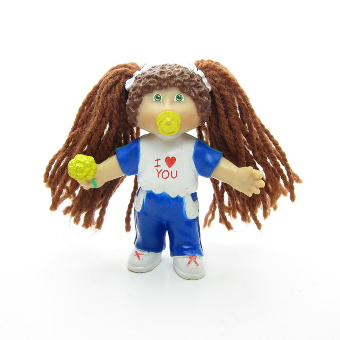 Cabbage Patch Kids miniature figurine with brown yarn hair and I Love You t-shirt