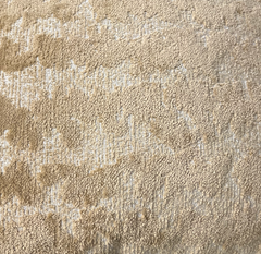 Close-up of the Decor Fifty-Five Coolney Pillow Sand, featuring a beige textured surface with small loops and raised areas for a soft, subtly uneven look.