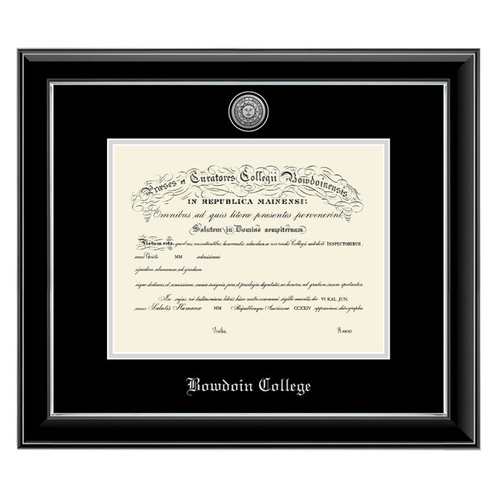 Diploma frame with glossy black moulding with silver fillet and black and silver matting. Silver sun seal medallion set into the mat on top of the diploma, BOWDOIN COLLEGE embossed in silver below.