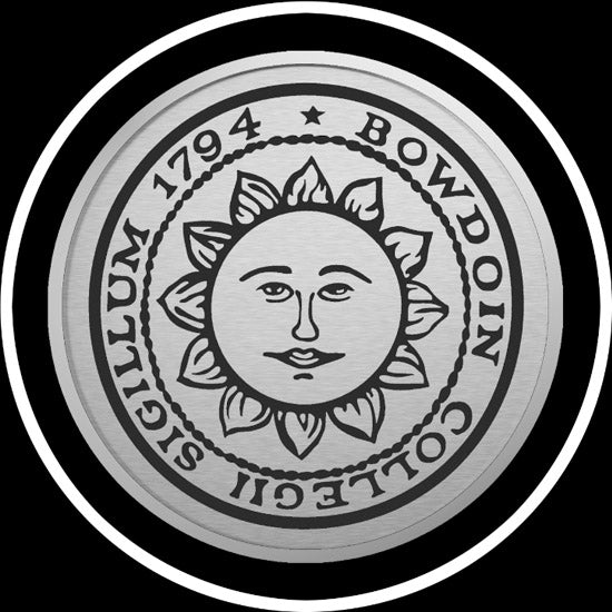 Closeup of engraved Bowdoin sun seal medallion in silver