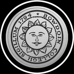 Closeup of engraved Bowdoin sun seal medallion in silver