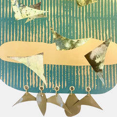 The artwork 'Flight' features abstract triangular shapes in metallic silver and cream against a striped teal background. Five handmade plastic charms dangle from grommets along the bottom, creating movement. Mixed media collage combines monotype prints, metallic paper, and acrylic paint. By Sunny Chapman.