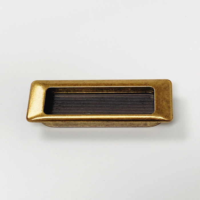 Forme Recessed Cabinet and Closet Pulls in Antique Brass Finish — form, finish and mounting detail