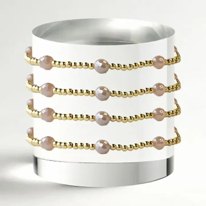 gold beaded bracelet with pink pearls