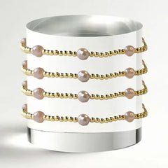 gold beaded bracelet with pink pearls