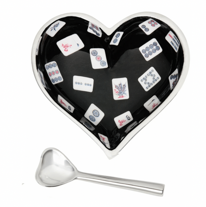The Happy Heart Bowl With Spoon - Mah Jong by Inspired Generations is a heart-shaped bowl with a black interior and mahjong tile pattern, paired with a small silver heart-shaped spoon.