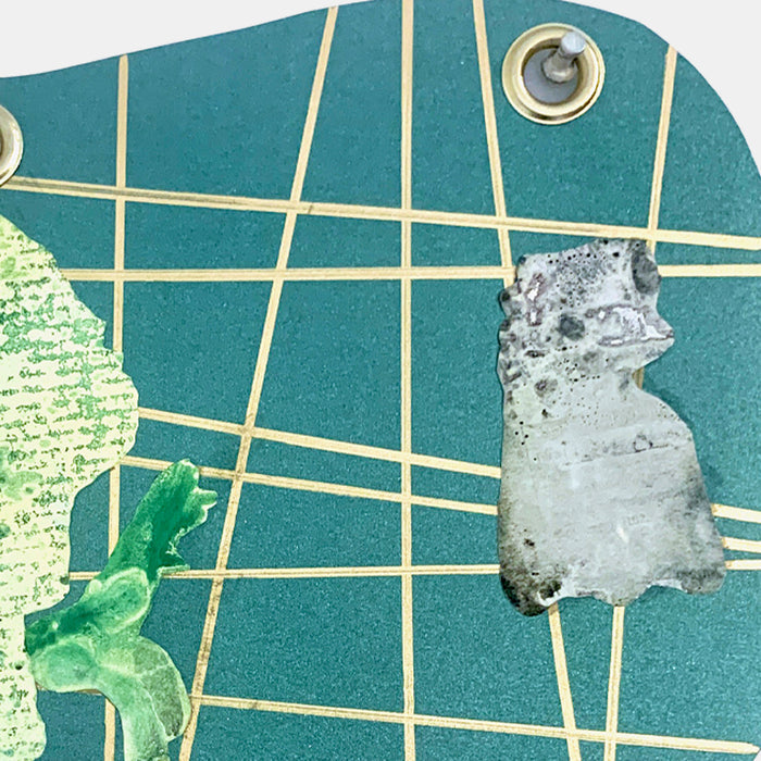 The artwork 'I Am Talking, Cat' features a geometric grid pattern on metallic teal paper with intersecting gold lines. Two silhouetted figures, one in textured green with handwritten text and another in mottled gray, appear against the gridded background. Metal grommets accent the corners. Mixed media collage by Sunny Chapman.