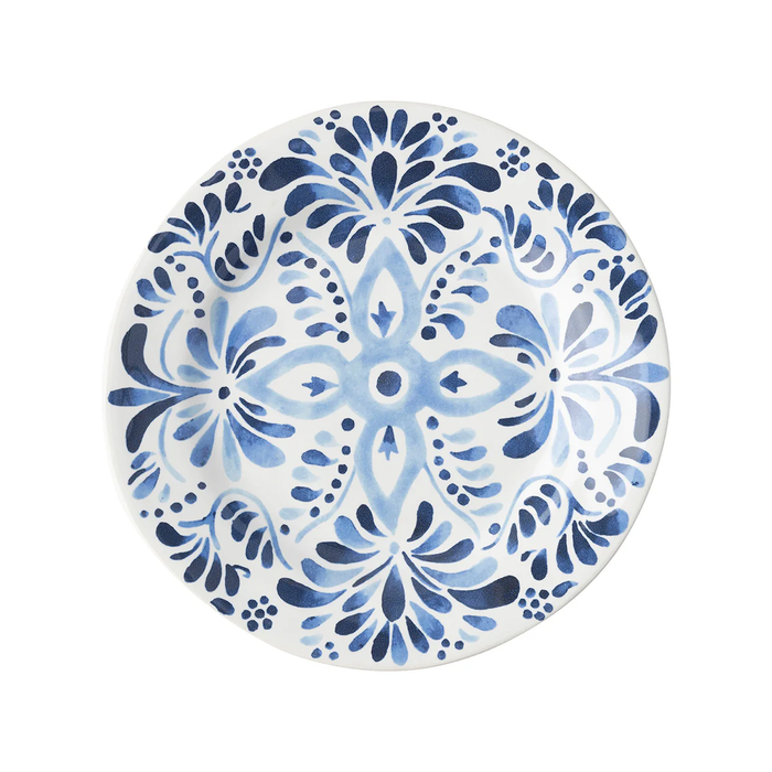 The Juliska Iberian Dinnerware is a round ceramic plate featuring an intricate blue and white floral and geometric pattern inspired by traditional hand-painted Iberian Journey cobalt blue tiles on a white background.