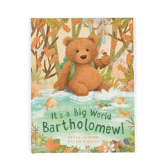 Book cover with a teddy bear in a forest setting and text 'It's a Big World Bartholomew!'.