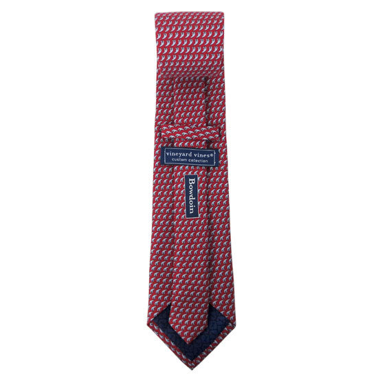 Back view of a red silk tie with an all-over imprint of the Hyde Plaza polar bear showing Vineyard Vines label and Bowdoin wordmark.