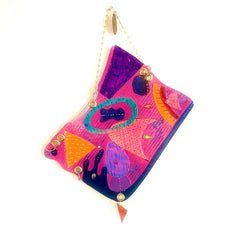 The artwork 'Seaside' features vibrant abstract shapes in pink, purple, orange, and turquoise acrylic paint on paper. Bold geometric patterns and organic forms create a dynamic composition with textured brushstrokes and flowing lines. The playful design incorporates dotted elements and curved shapes suggesting coastal motifs. By Sunny Chapman.